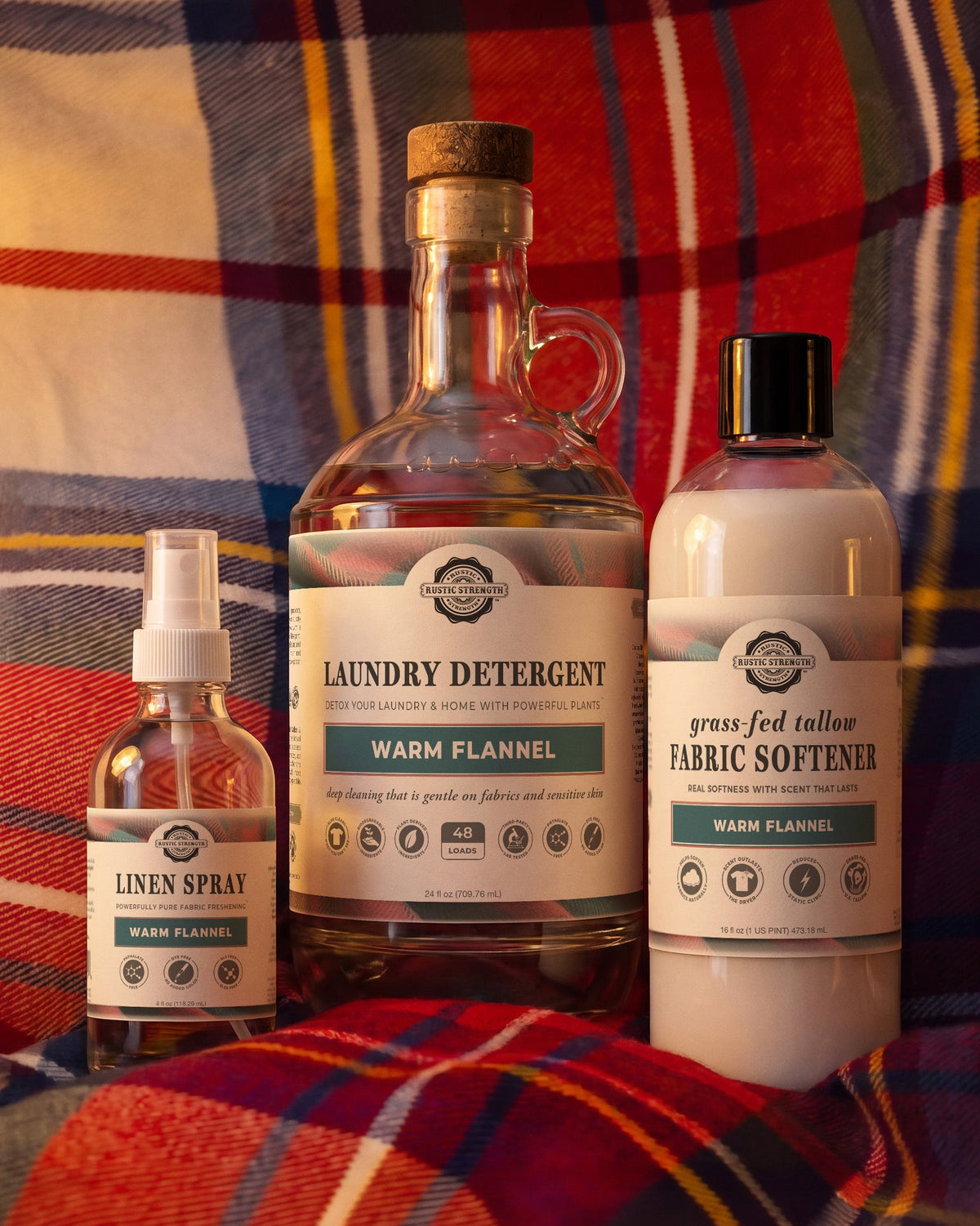 Rustic Strength, Laundry Set, Laundry Detergent, Linen Spray and Grass-fed Tallow Fabric Softener, Warm Flannel, shown setting on a soft plaid flannel fabric