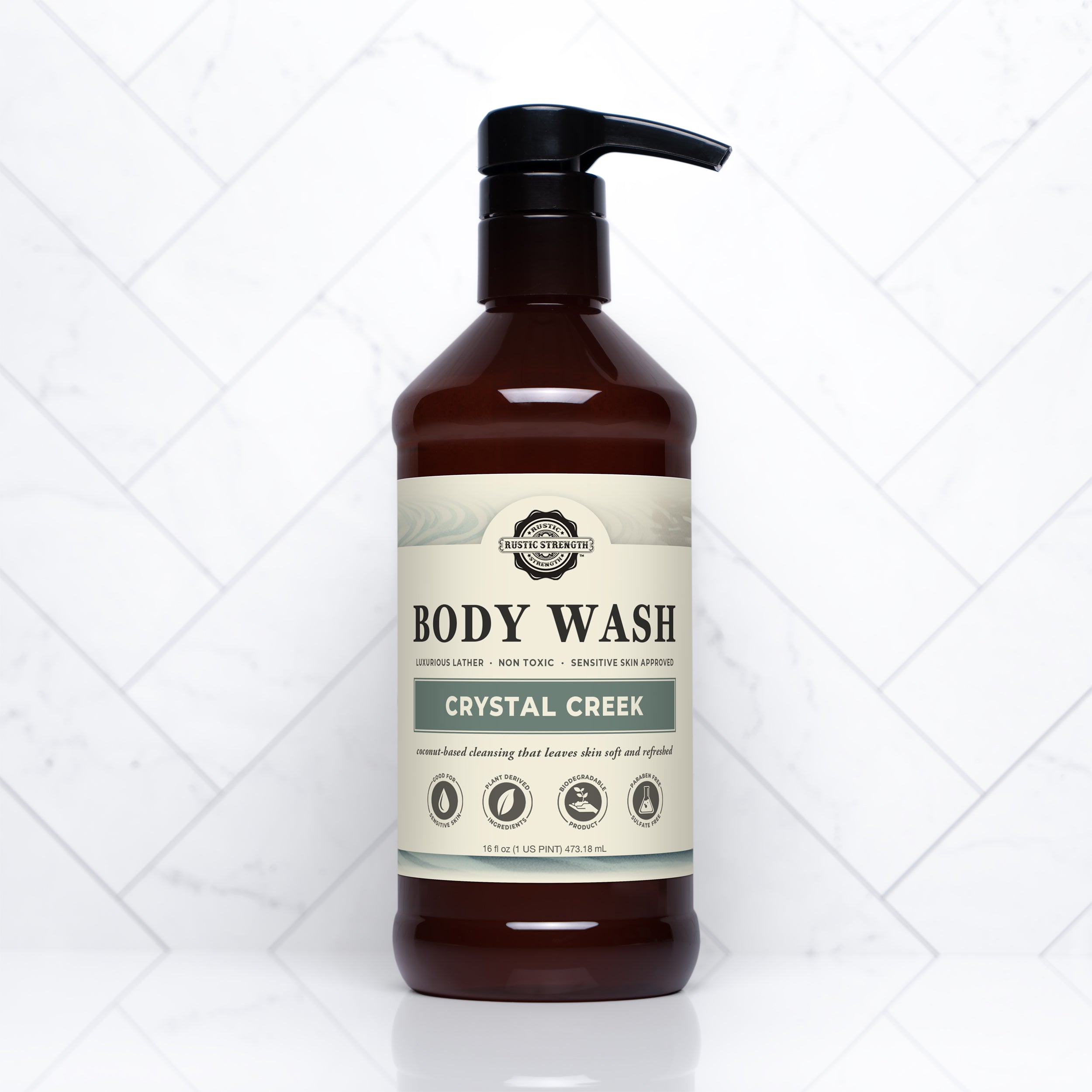 Bottle of Crystal Creek body wash on a white tiled background