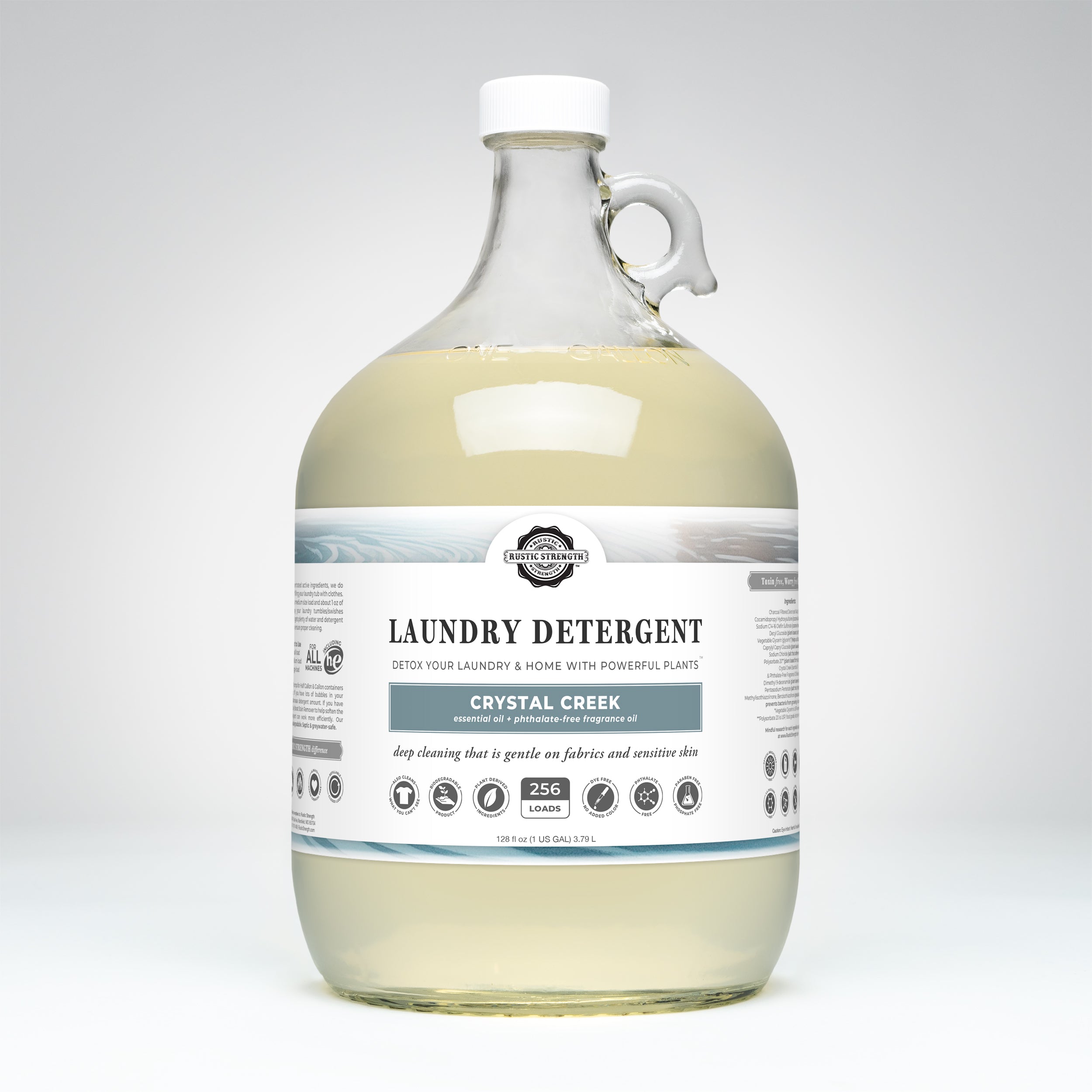 Gallon glass bottle of Crystal Creek laundry detergent on a white background