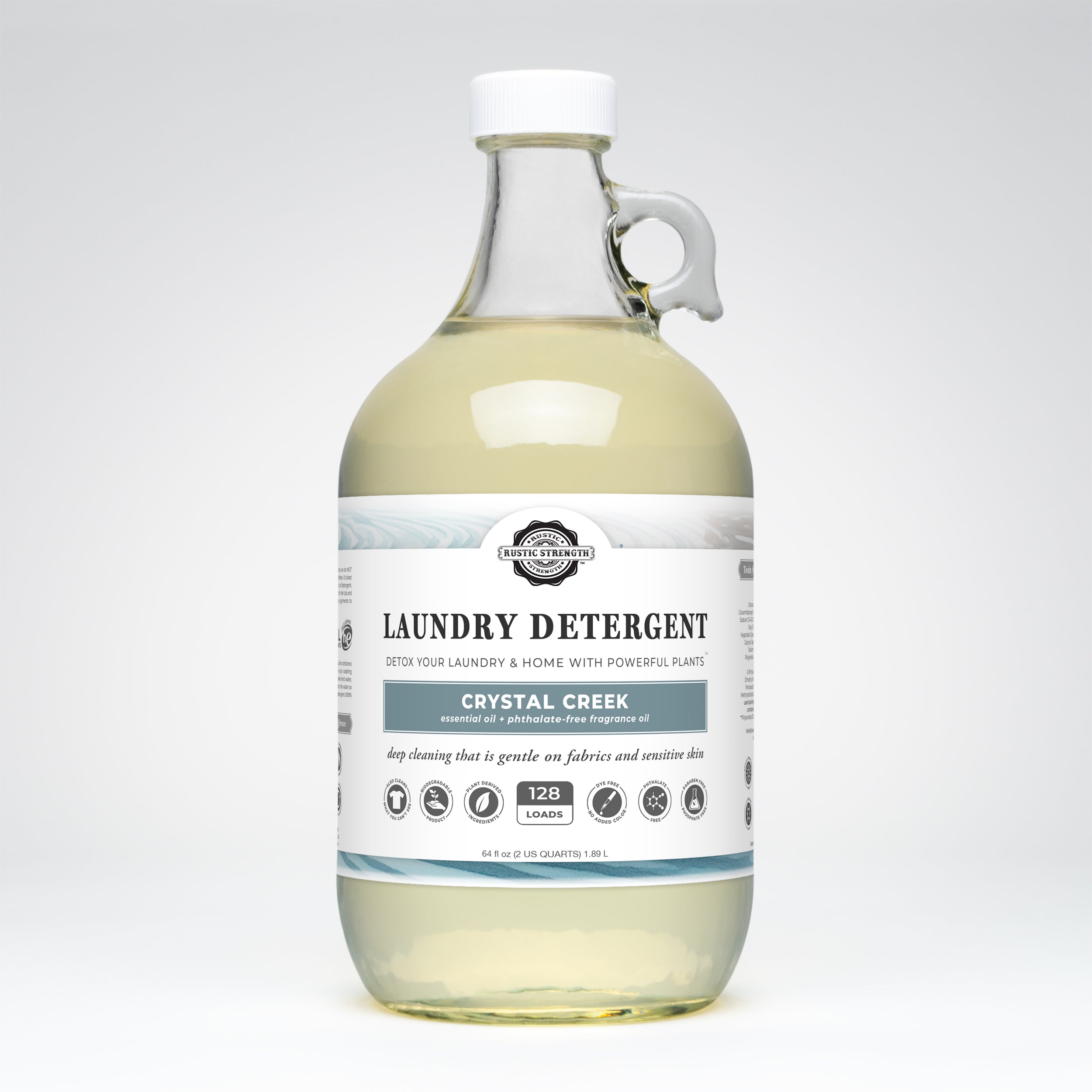 Half gallon glass bottle of Crystal Creek scented laundry detergent on a white background