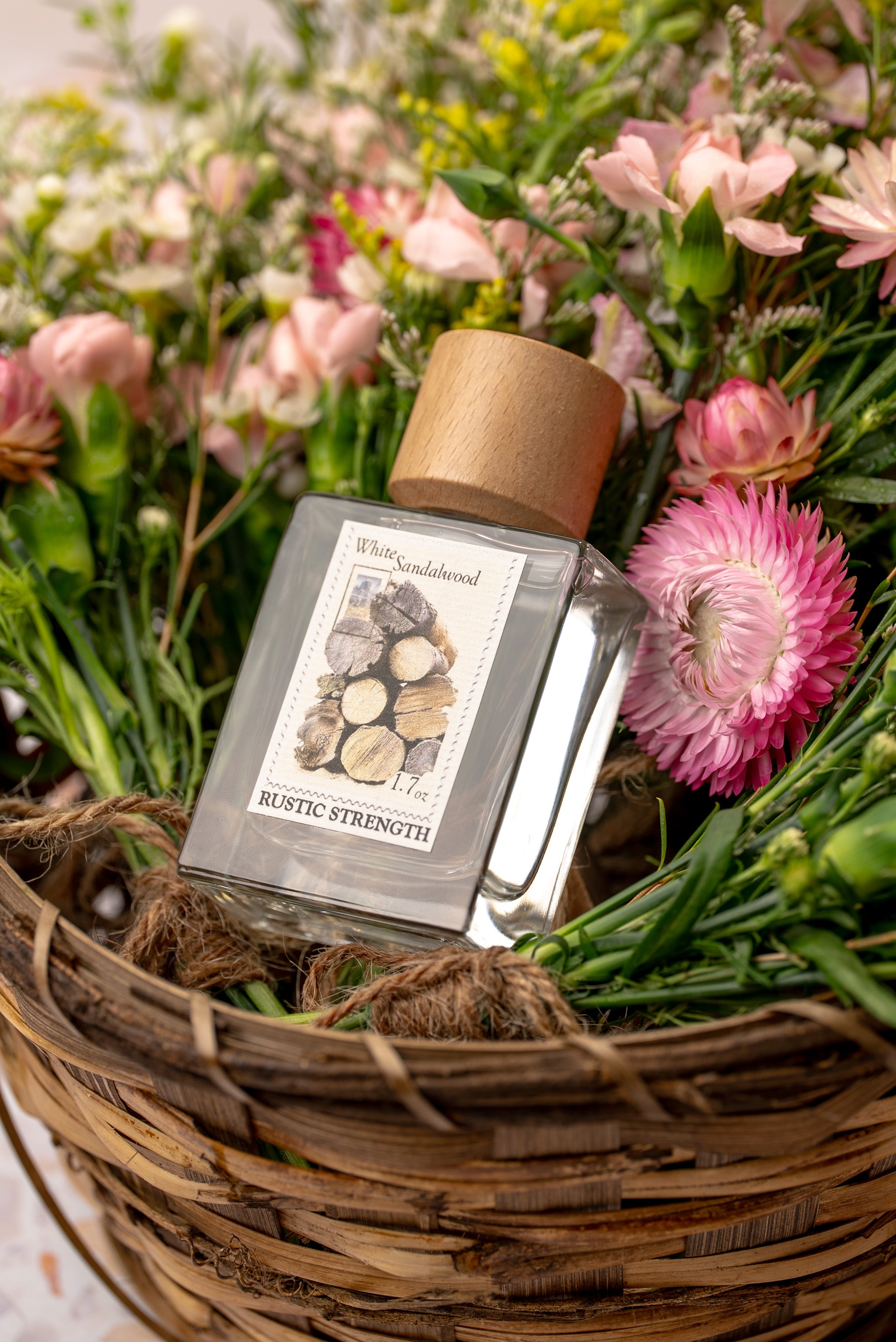 White Sandalwood perfume in a 1.7 ounce glass bottle sitting in a basket of flowers.