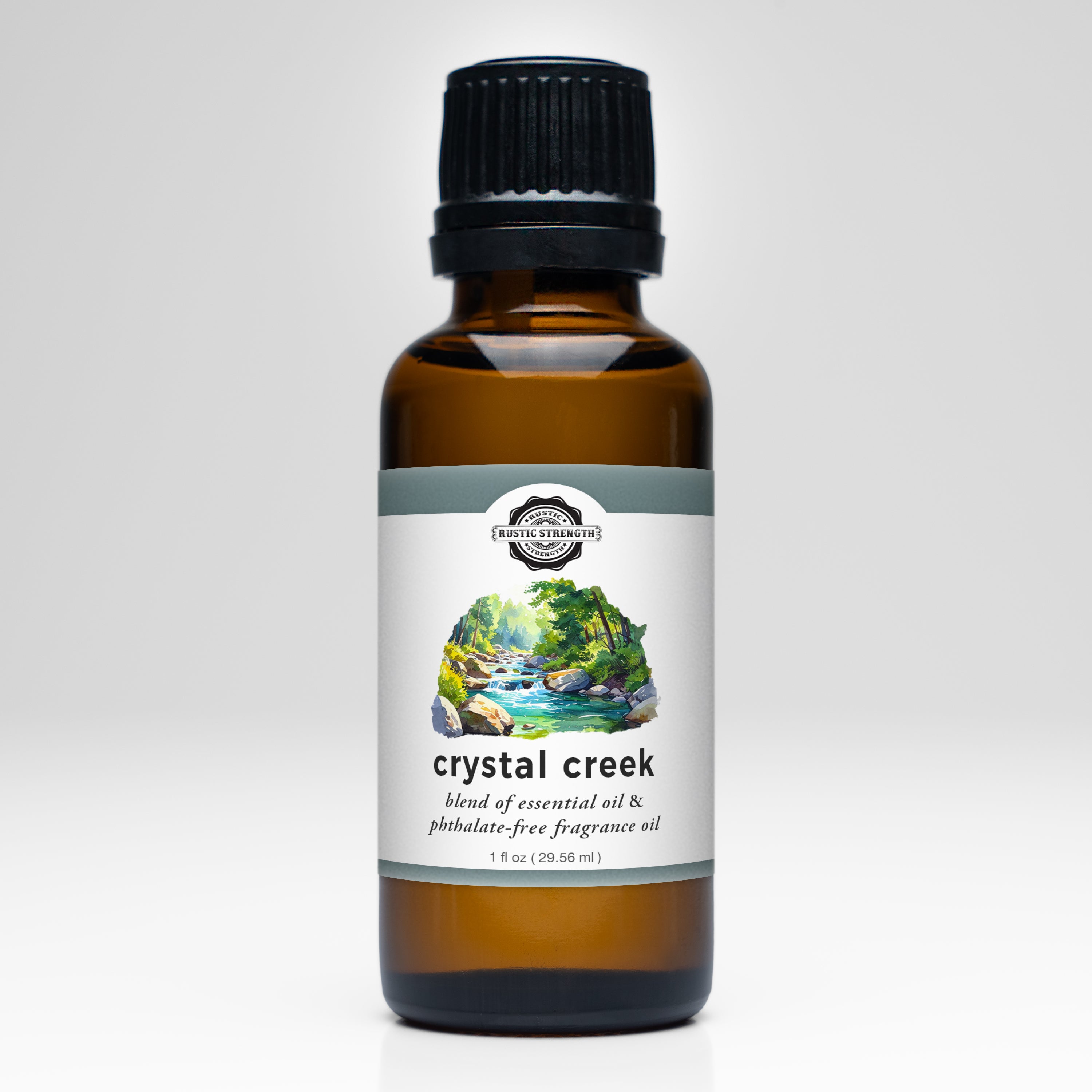Bottle of Crystal Creek fragrance oil with a scenic label on a white background