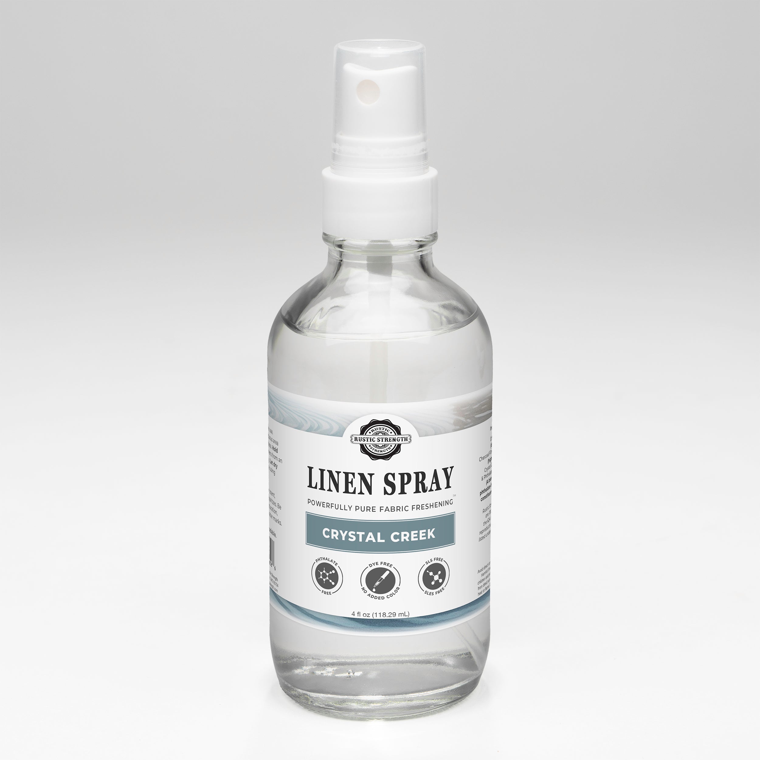 Crystal Creek scented Linen spray bottle with a label on a gray background