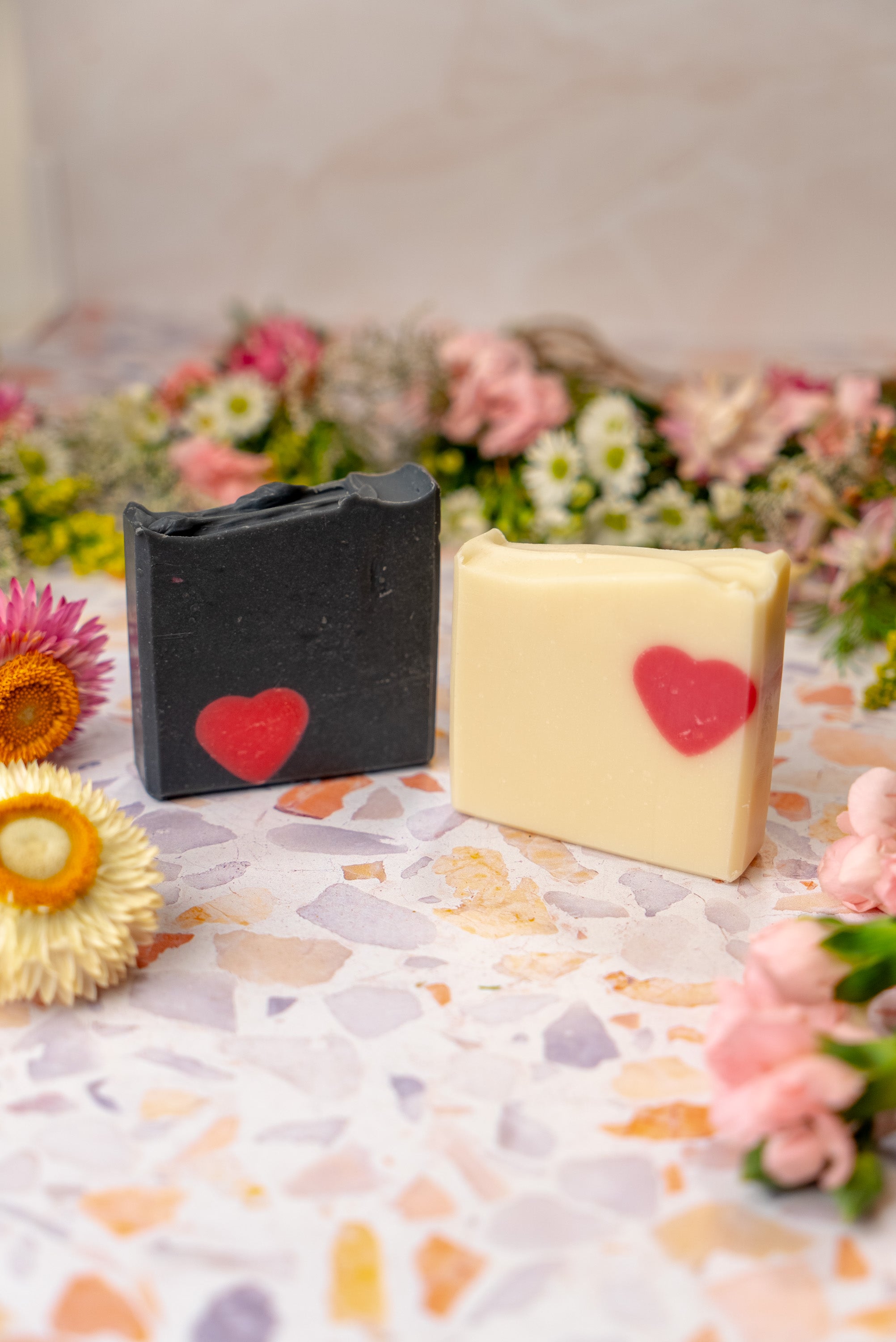 His and hers Valentine's Day soap bars surrounded by  flowers
