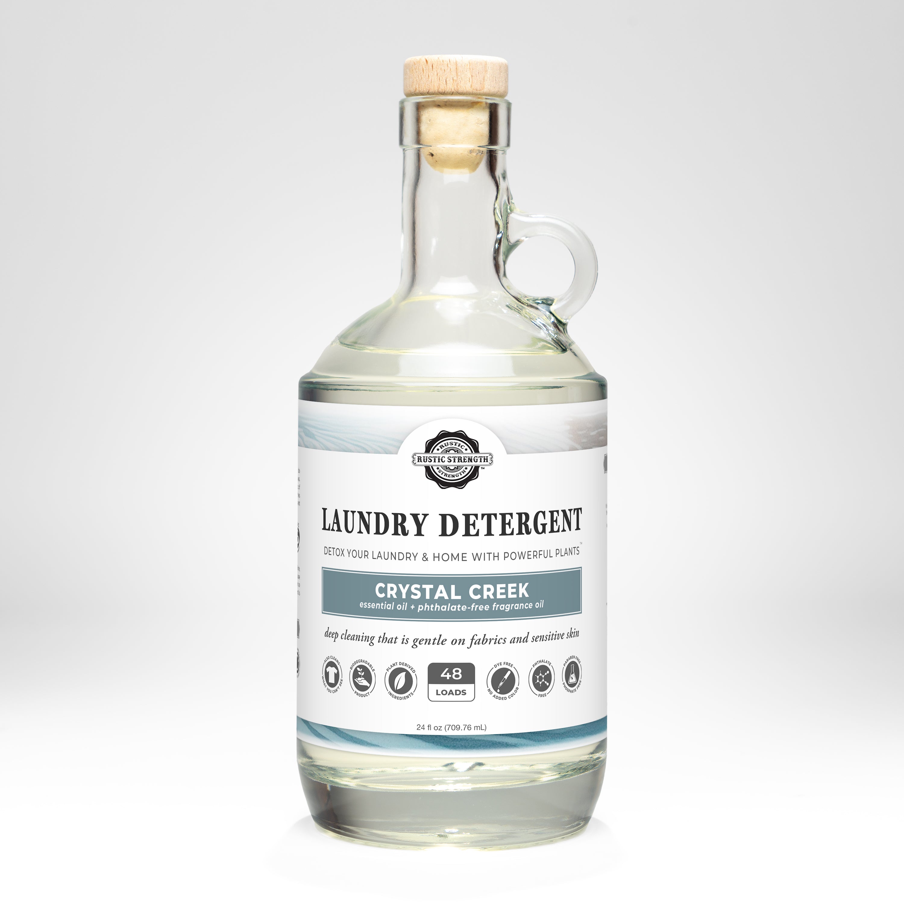 Glass bottle of Crystal Creek laundry detergent on a white background