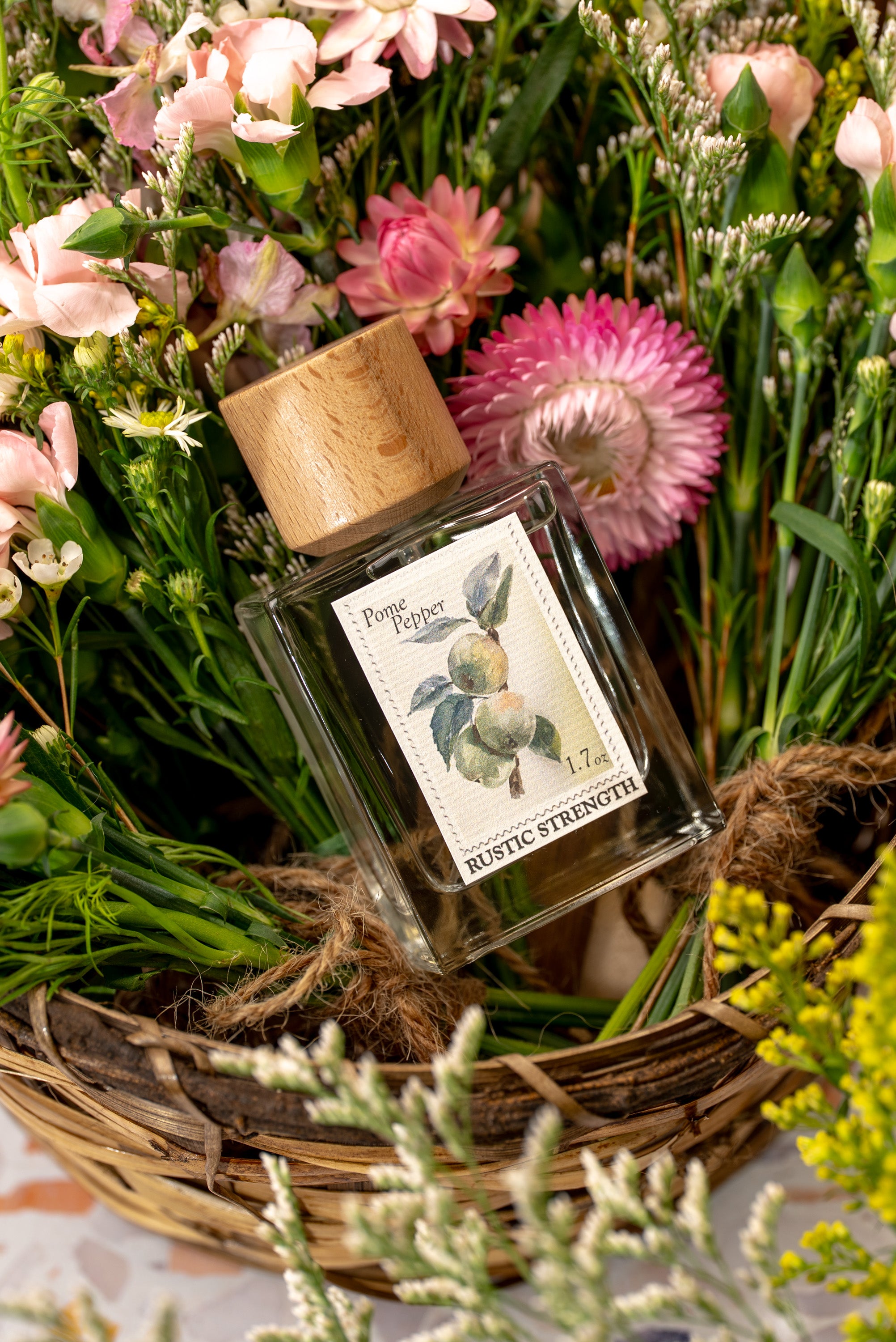 Pome Pepper perfume in a 1.7 ounce glass bottle sitting in a basket of flowers.