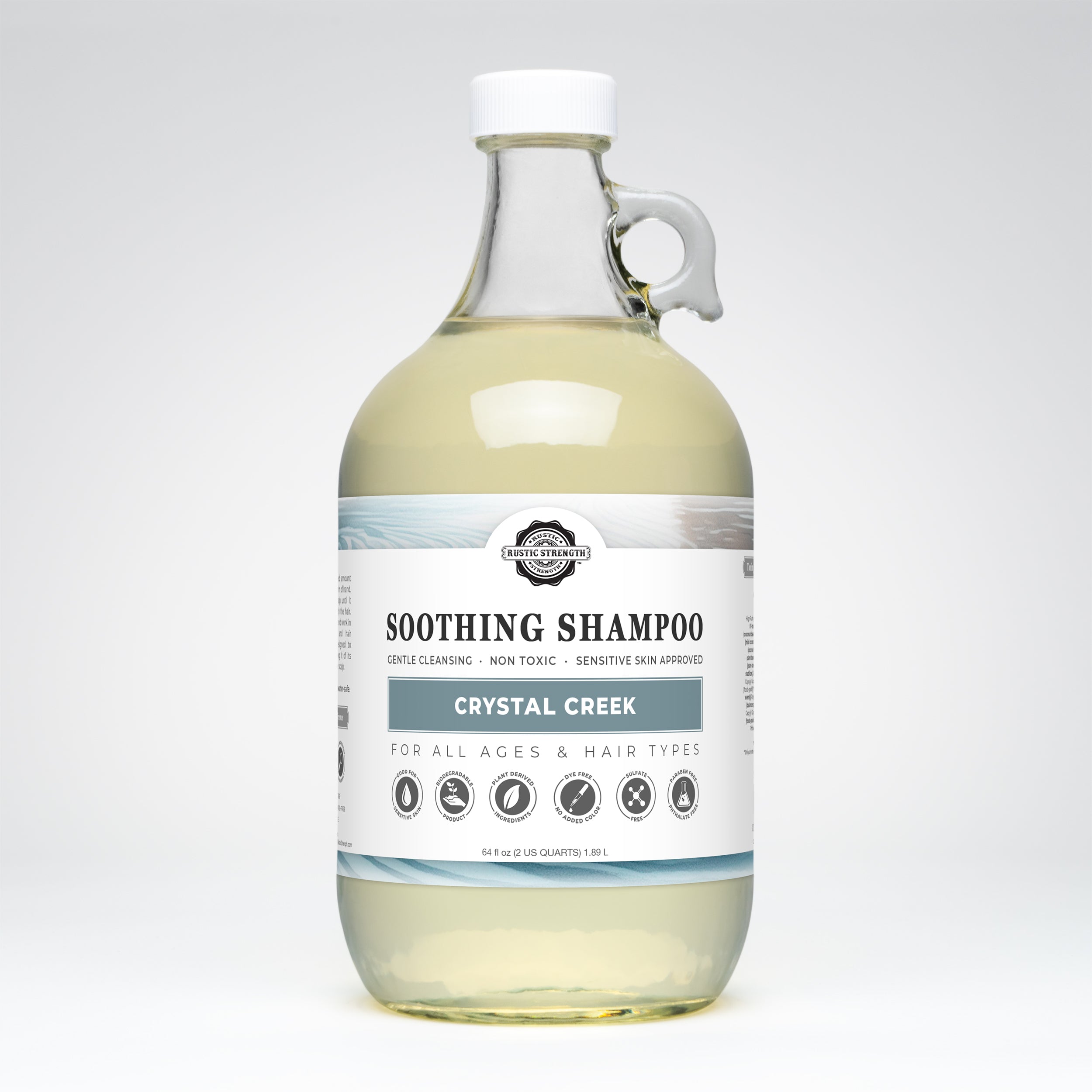 half gallon glass bottle of Crystal Creek soothing shampoo on a white background